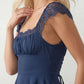 Women's Soraia Lace Lace-Up Mini Dress featuring elegant floral lace, a square neckline with a ruched bust, scalloped cap sleeves, a corset-style lace-up back, and a flattering A-line mini skirt finished with a scalloped lace hem, perfect for weddings, race days, garden parties and special occasions.