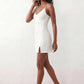 Woman wearing the spaghetti strap low back fitted mini dress featuring adjustable straps, a figure-hugging sheath silhouette, elegant low open back, side slit, and mini-length hem, perfect for parties, weddings, and evening occasions.