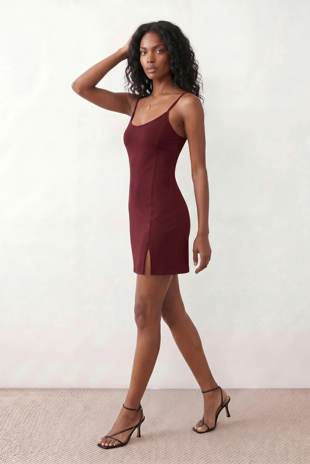 Woman wearing the spaghetti strap low back fitted mini dress featuring adjustable straps, a figure-hugging sheath silhouette, elegant low open back, side slit, and mini-length hem, perfect for parties, weddings, and evening occasions.