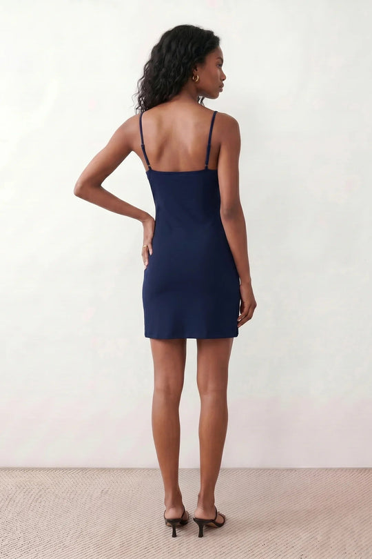 Woman wearing the spaghetti strap low back fitted mini dress featuring adjustable straps, a figure-hugging sheath silhouette, elegant low open back, side slit, and mini-length hem, perfect for parties, weddings, and evening occasions.