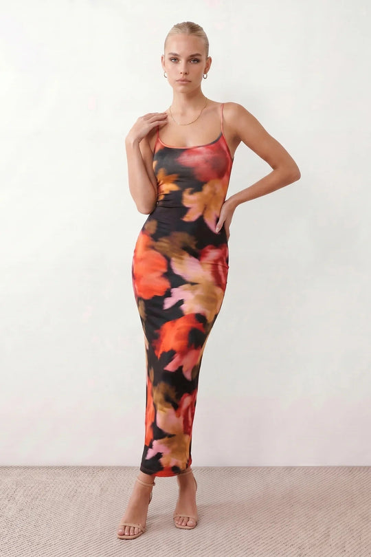 Women's spaghetti strap floral maxi dress with a fitted sheath silhouette, round neckline, adjustable straps, and elegant low open back in a red and black floral print, perfect for weddings and special occasions.