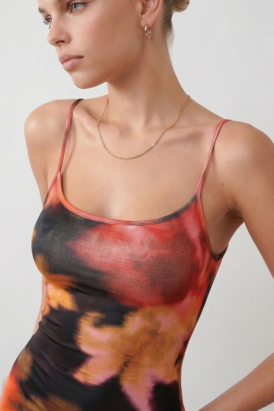 Women's spaghetti strap floral maxi dress with a fitted sheath silhouette, round neckline, adjustable straps, and elegant low open back in a red and black floral print, perfect for weddings and special occasions.