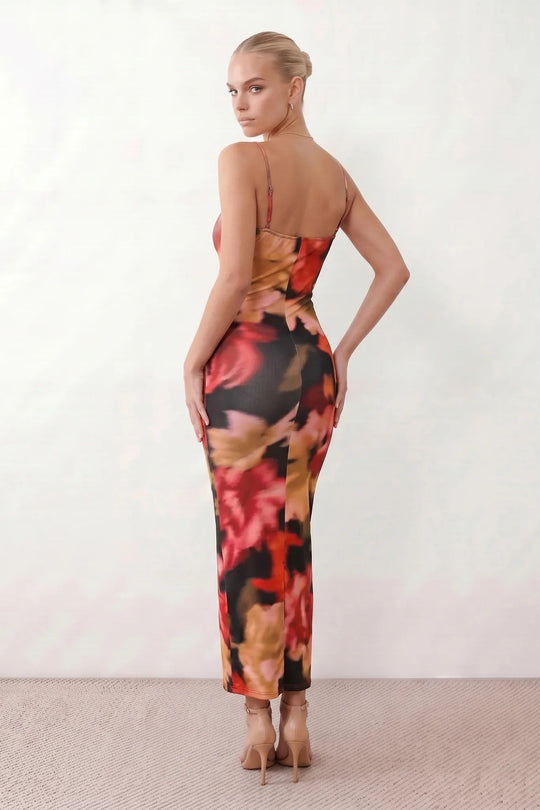 Women's spaghetti strap floral maxi dress with a fitted sheath silhouette, round neckline, adjustable straps, and elegant low open back in a red and black floral print, perfect for weddings and special occasions.