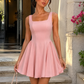 Women’s square neck pleated mini dress featuring delicate shoulder straps, a fitted bodice, and a flowing A-line skirt in soft pale pink for parties and special occasions.