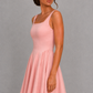 Women’s square neck pleated mini dress featuring delicate shoulder straps, a fitted bodice, and a flowing A-line skirt in soft pale pink for parties and special occasions.