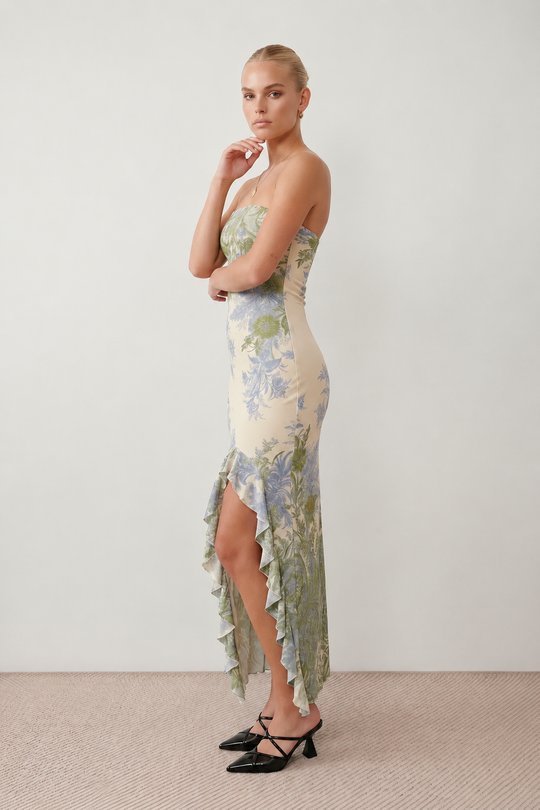 Woman wearing the Madelyn Strapless Floral Maxi Dress featuring a strapless square neckline, fitted bodice, botanical floral print, cascading layered ruffle front split, and flowing maxi-length skirt, ideal for weddings, race days, garden parties, and formal occasions.