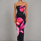 Woman wearing a strapless floral print midi dress with a fitted bodice and fit-and-flare silhouette in soft jersey fabric, ideal for wedding guests, garden parties, and special occasions.