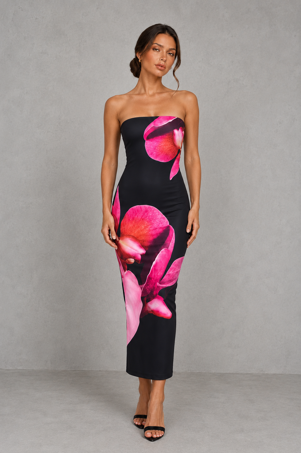 Woman wearing a strapless floral print midi dress with a fitted bodice and fit-and-flare silhouette in soft jersey fabric, ideal for wedding guests, garden parties, and special occasions.