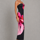 Woman wearing a strapless floral print midi dress with a fitted bodice and fit-and-flare silhouette in soft jersey fabric, ideal for wedding guests, garden parties, and special occasions.