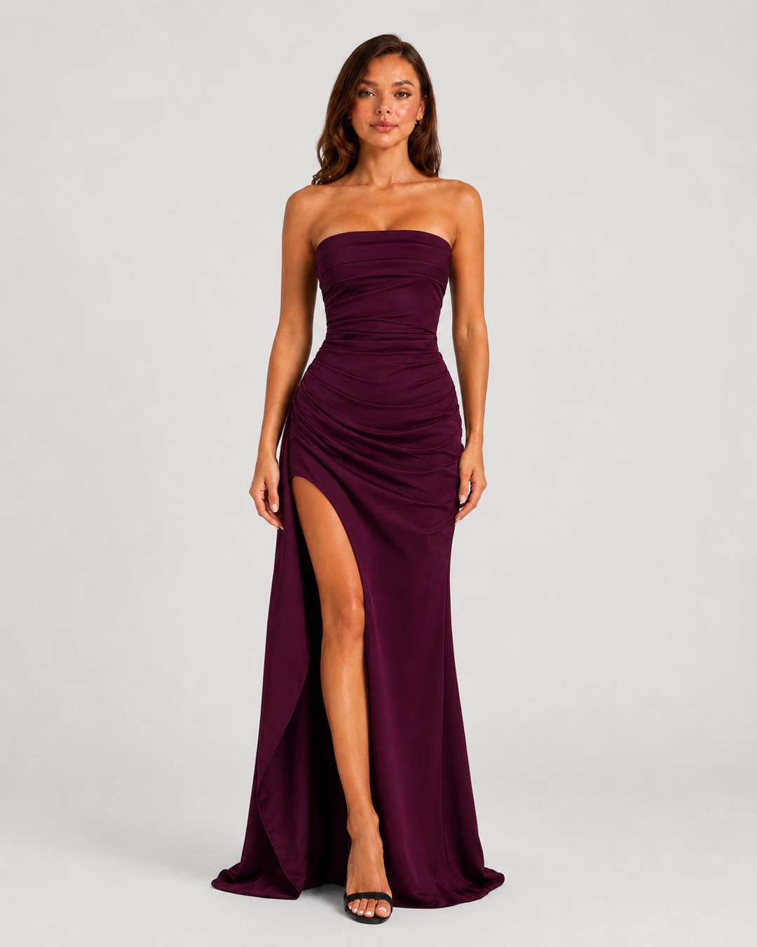 Women's strapless ruched maxi dress in double stretch crepe featuring a figure-hugging silhouette, thigh-high split, and cascading drape ruffle detail.