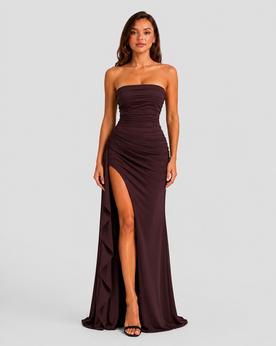 Women's strapless ruched maxi dress in double stretch crepe featuring a figure-hugging silhouette, thigh-high split, and cascading drape ruffle detail.