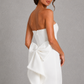 Women's strapless pearl trim maxi dress in premium crepe with a fitted bodice, elegant column skirt, centre back split, and detachable oversized bow for formal occasions.