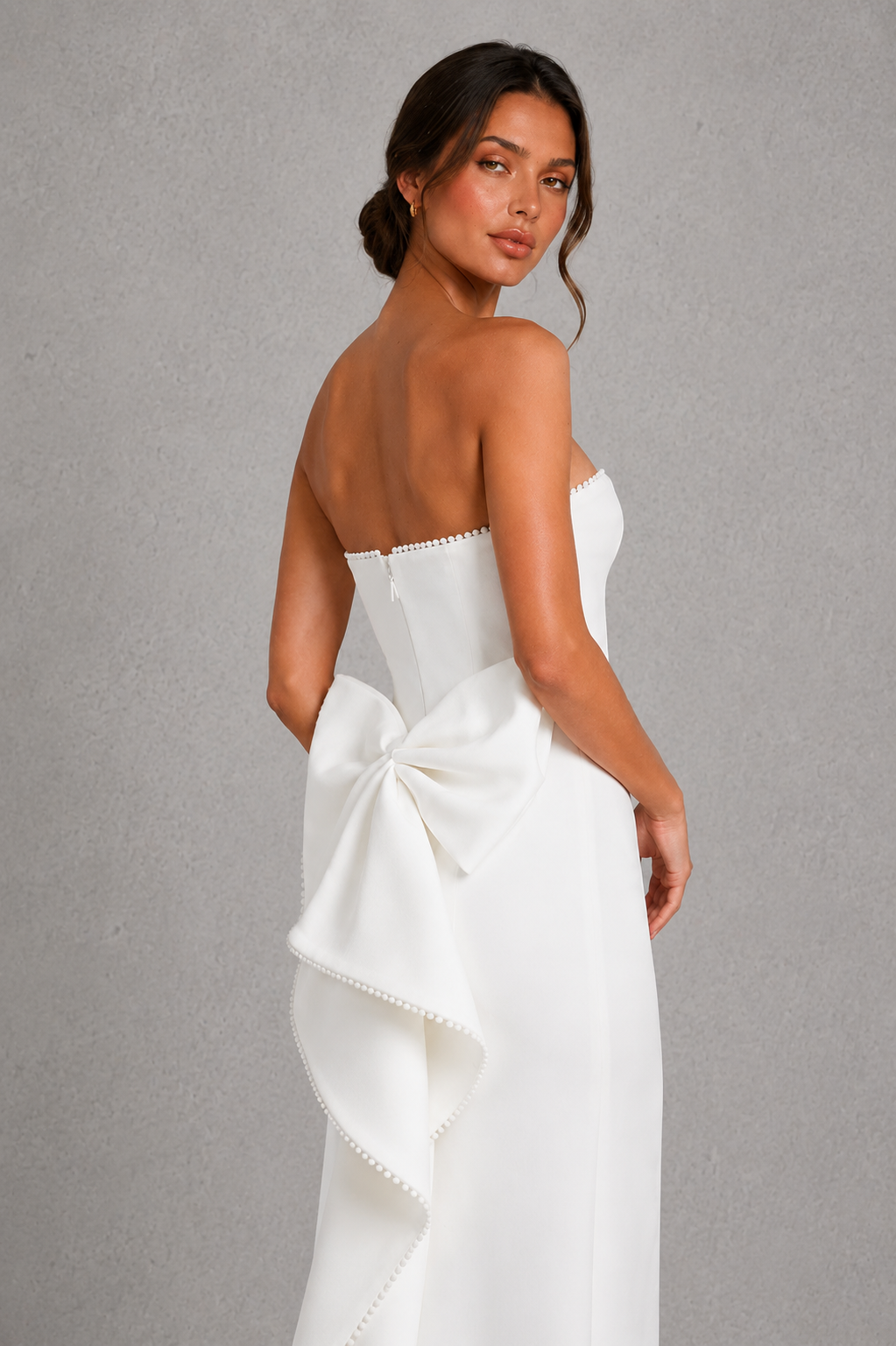 Women's strapless pearl trim maxi dress in premium crepe with a fitted bodice, elegant column skirt, centre back split, and detachable oversized bow for formal occasions.
