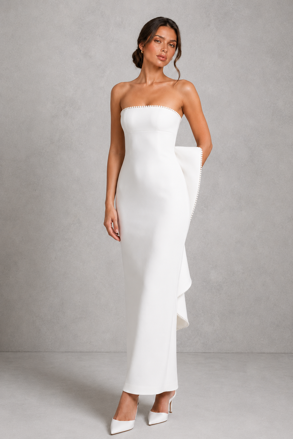 Women's strapless pearl trim maxi dress in premium crepe with a fitted bodice, elegant column skirt, centre back split, and detachable oversized bow for formal occasions.