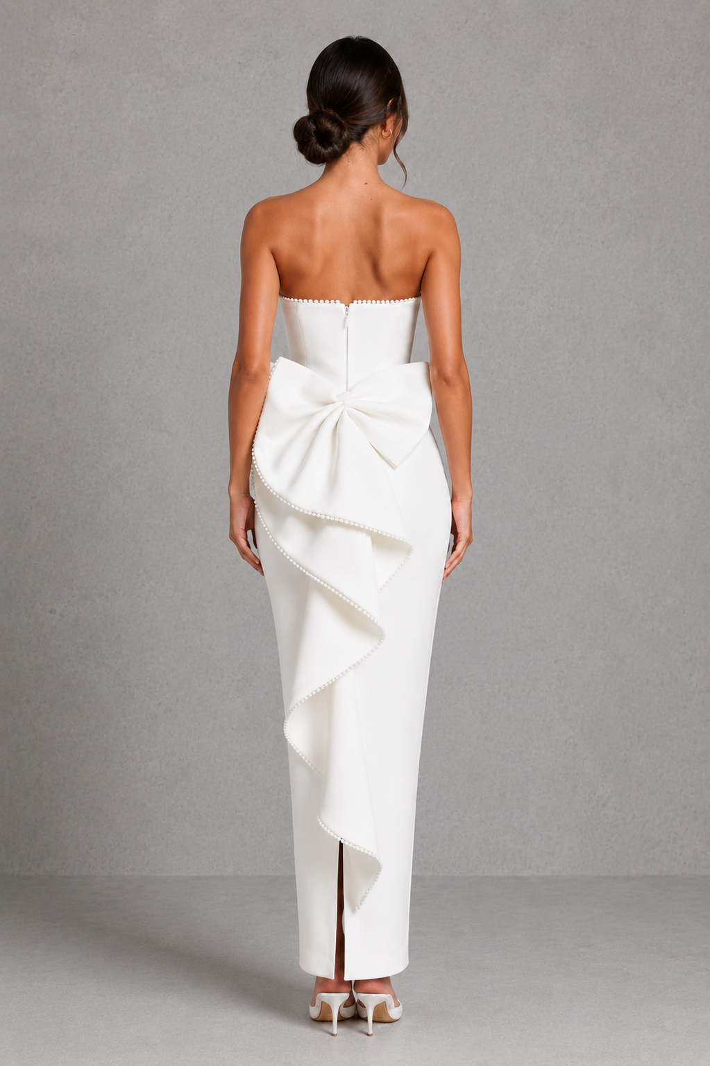 Women's strapless pearl trim maxi dress in premium crepe with a fitted bodice, elegant column skirt, centre back split, and detachable oversized bow for formal occasions.