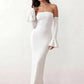 Woman wearing the strapless mermaid maxi dress with a sweetheart neckline, statement shoulder bow, matching long bell-cuff gloves, fitted silhouette and floor-length hem, ideal for weddings, black-tie events and formal occasions.