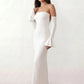 Woman wearing the strapless mermaid maxi dress with a sweetheart neckline, statement shoulder bow, matching long bell-cuff gloves, fitted silhouette and floor-length hem, ideal for weddings, black-tie events and formal occasions.