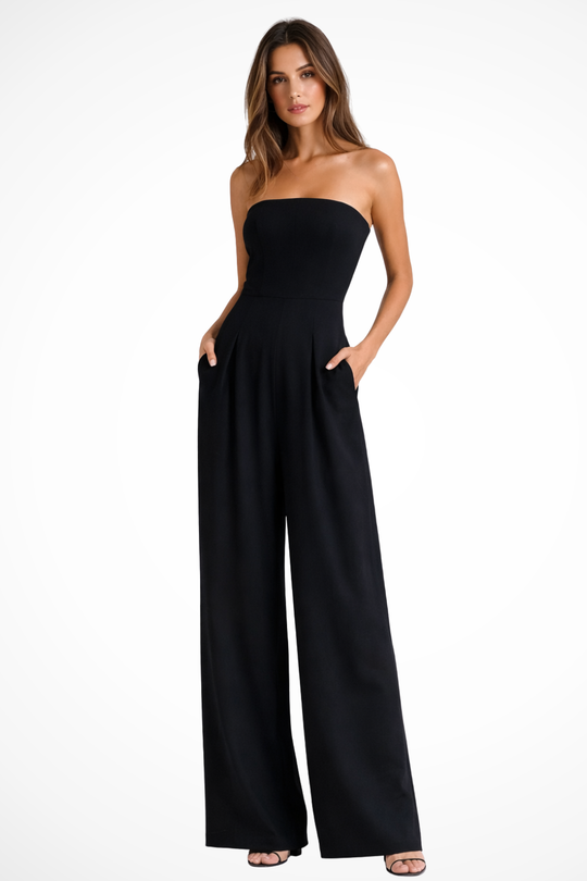 Woman wearing a black strapless jumpsuit on a white background