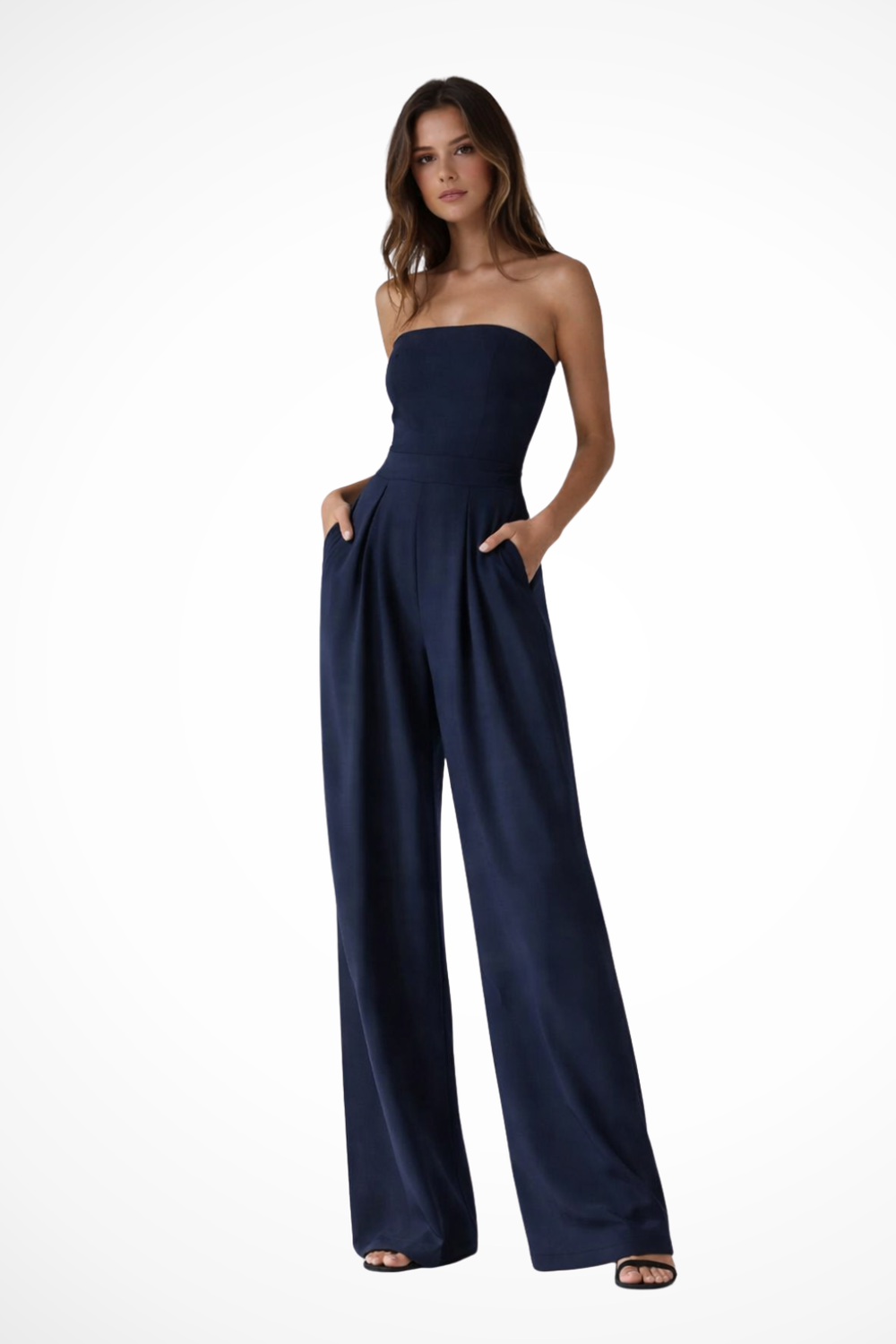 Woman wearing a strapless navy jumpsuit on a white background