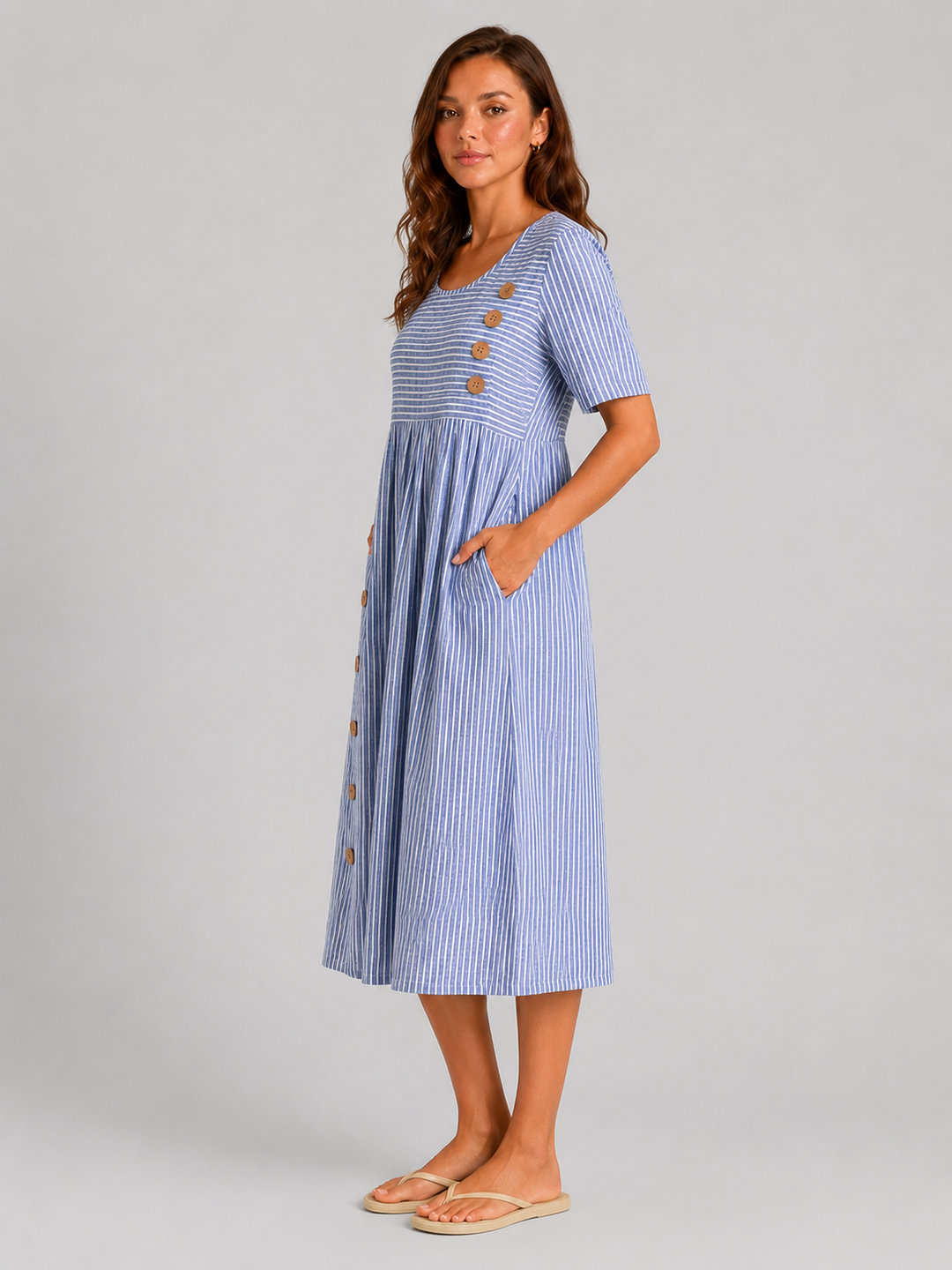 Women's striped midi dress featuring side button detailing, relaxed A-line silhouette, lightweight fabric, and practical side pockets for effortless everyday style.