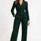 Woman wearing a green jumpsuit on a white background