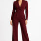 Woman wearing a burgundy jumpsuit on a white background