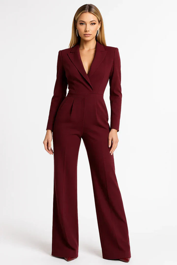 Woman wearing a burgundy jumpsuit on a white background