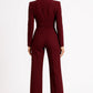 Burgundy jumpsuit worn by a model on a white background