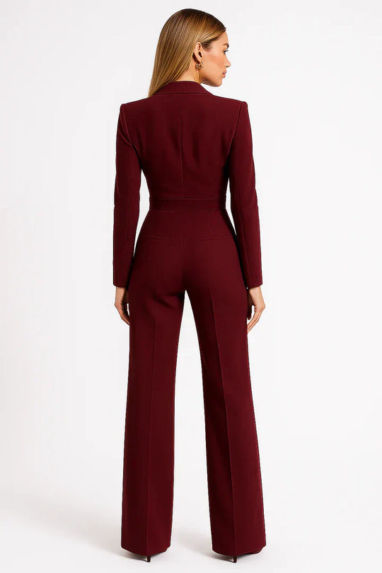 Burgundy jumpsuit worn by a model on a white background