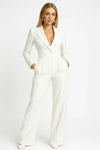 Woman wearing a white jumpsuit on a white background