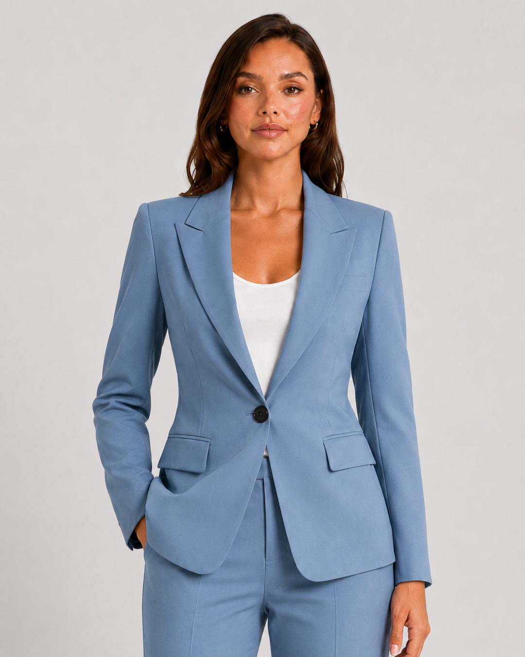 Woman wearing a tailored blazer and high-waist trousers set featuring a structured silhouette, clean lines, and sophisticated modern tailoring.