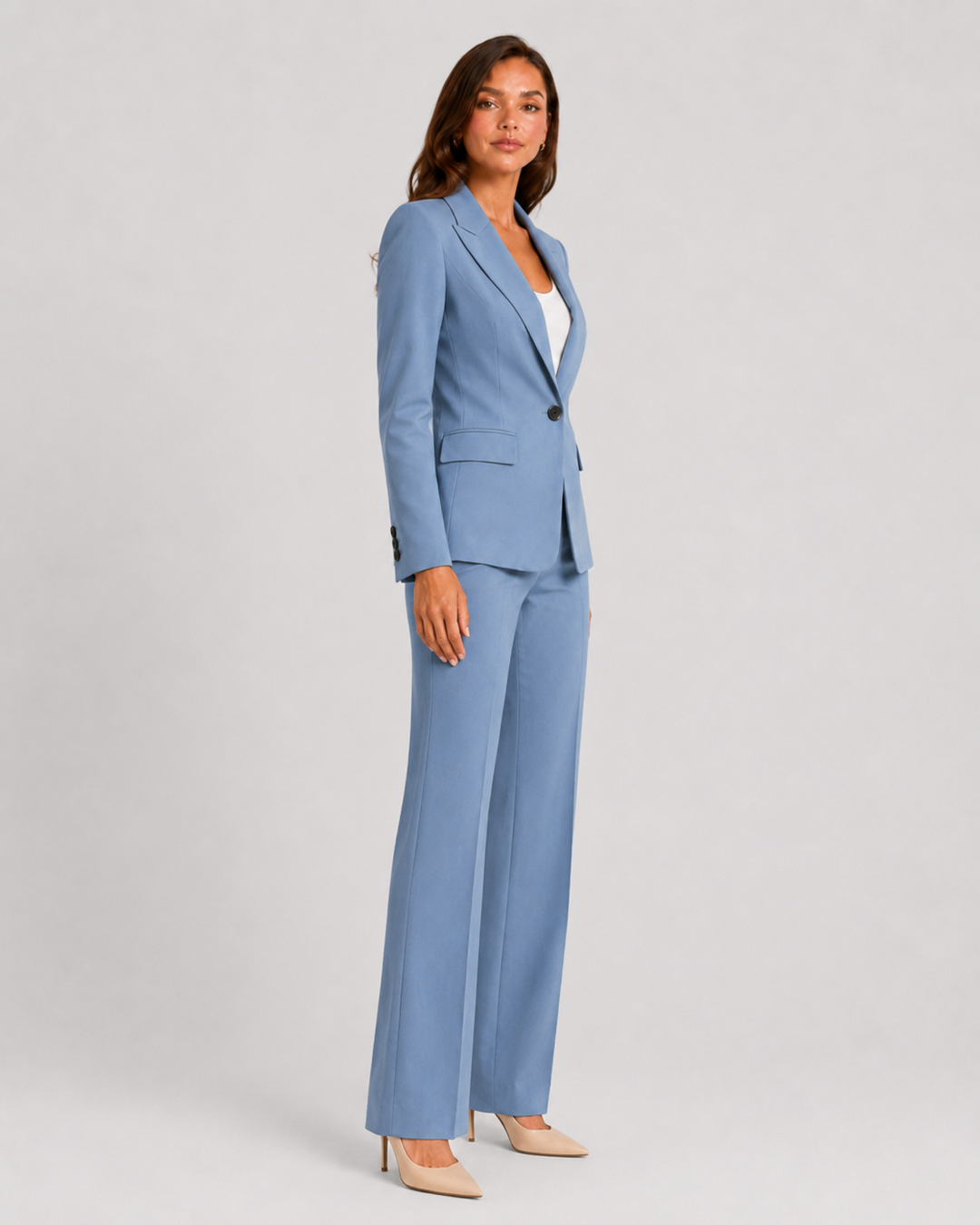 Woman wearing a tailored blazer and high-waist trousers set featuring a structured silhouette, clean lines, and sophisticated modern tailoring.