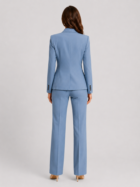 Woman wearing a tailored blazer and high-waist trousers set featuring a structured silhouette, clean lines, and sophisticated modern tailoring.