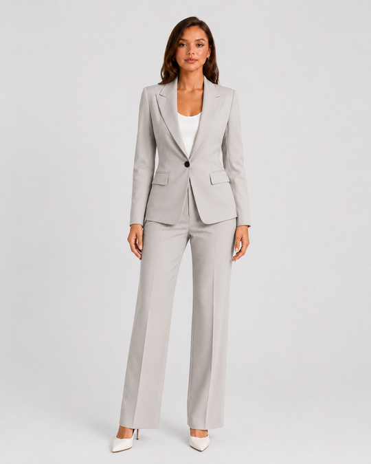 Woman wearing a tailored blazer and high-waist trousers set featuring a structured silhouette, clean lines, and sophisticated modern tailoring.
