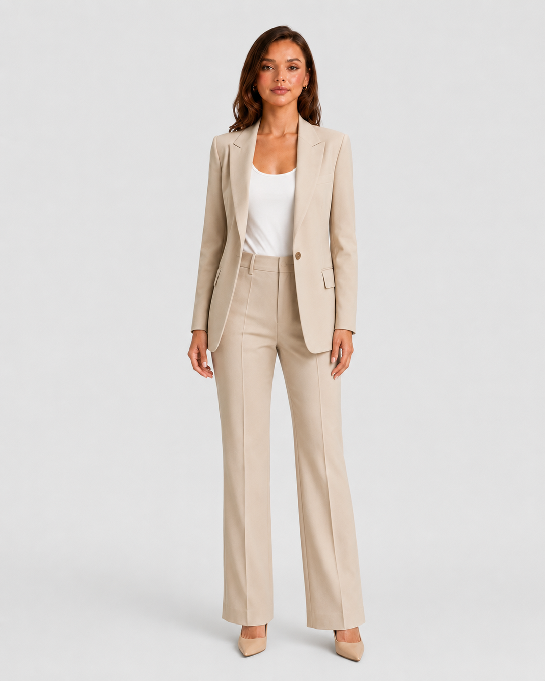 Woman wearing a tailored blazer and high-waist trousers set featuring a structured silhouette, clean lines, and sophisticated modern tailoring.