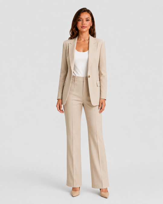 Woman wearing a tailored blazer and high-waist trousers set featuring a structured silhouette, clean lines, and sophisticated modern tailoring.