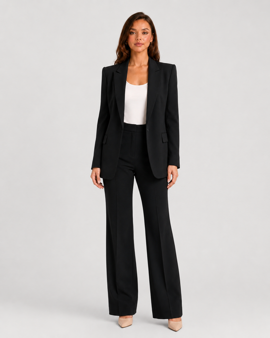 Woman wearing a tailored blazer and high-waist trousers set featuring a structured silhouette, clean lines, and sophisticated modern tailoring.