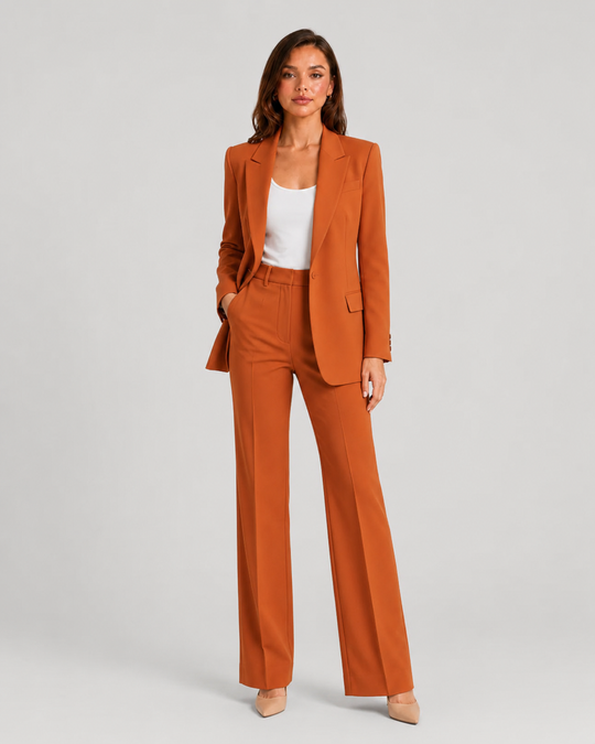Woman wearing a tailored blazer and high-waist trousers set featuring a structured silhouette, clean lines, and sophisticated modern tailoring.