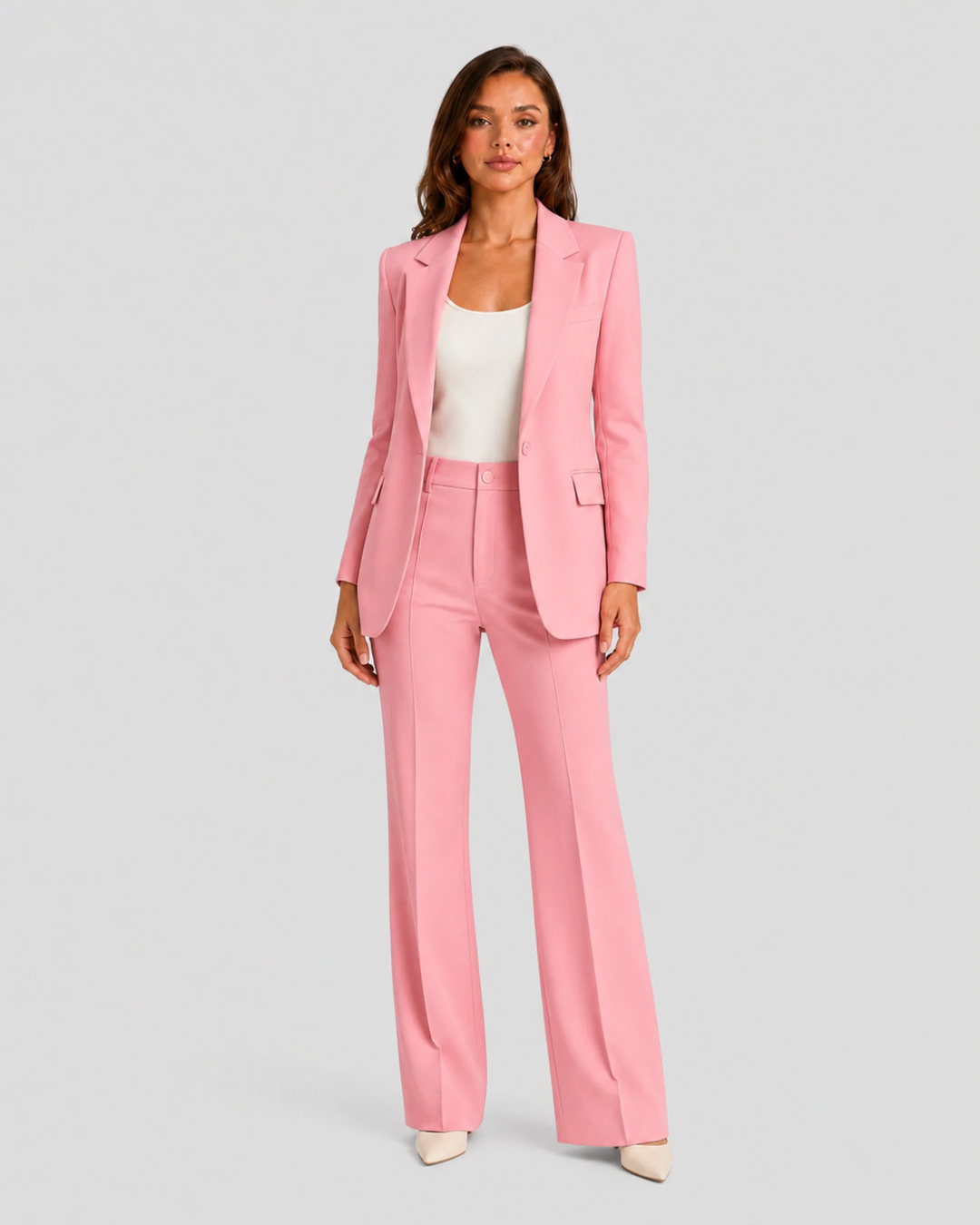 Woman wearing a tailored blazer and high-waist trousers set featuring a structured silhouette, clean lines, and sophisticated modern tailoring.