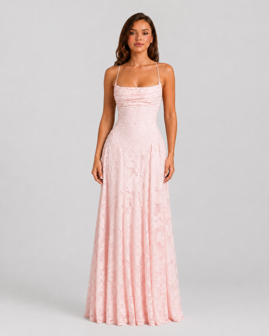 Woman wearing a textured floral maxi dress with a fitted bodice, delicate straps, elegant neckline, and flowing skirt for wedding guest and occasion wear.