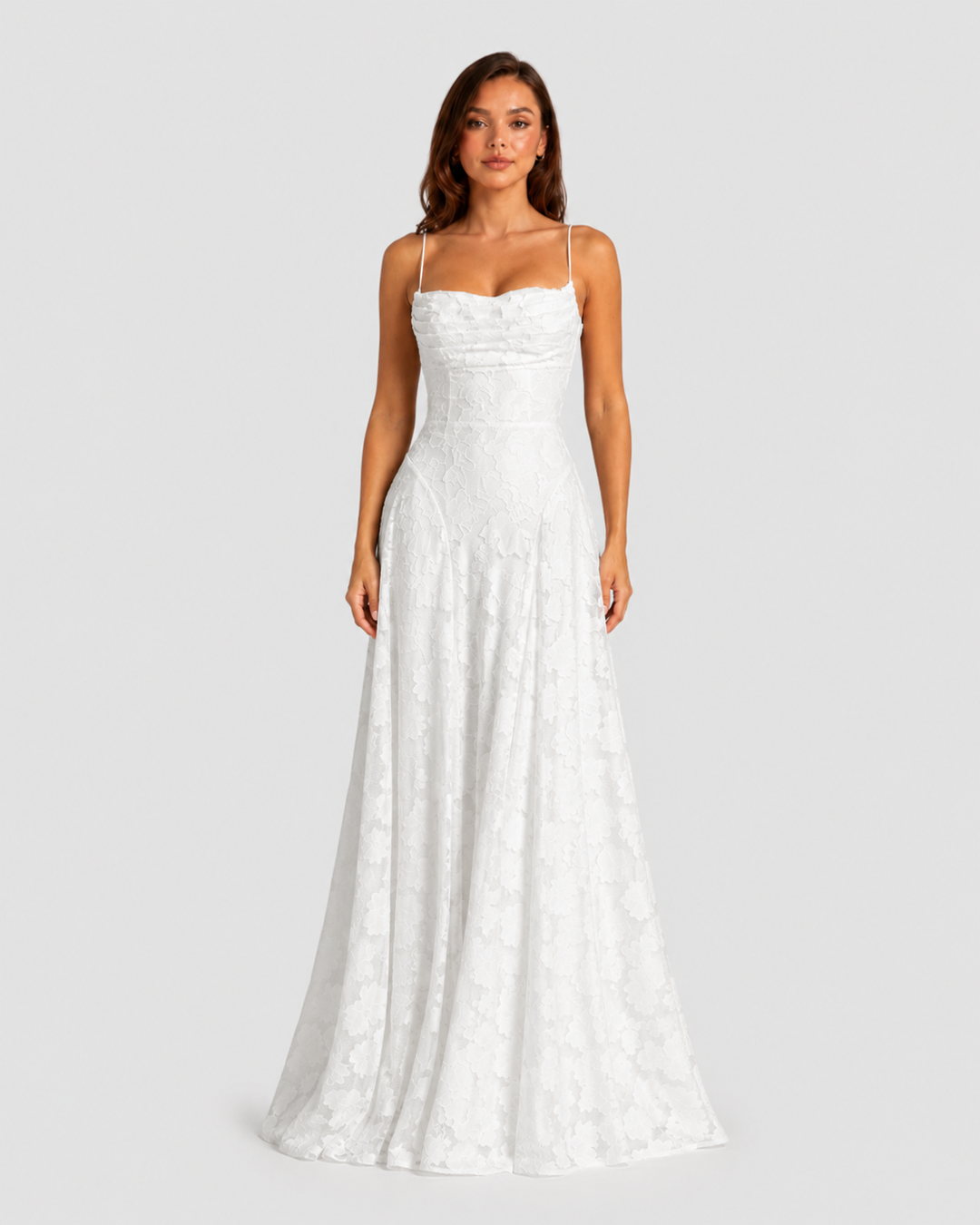 Woman wearing a textured floral maxi dress with a fitted bodice, delicate straps, elegant neckline, and flowing skirt for wedding guest and occasion wear.
