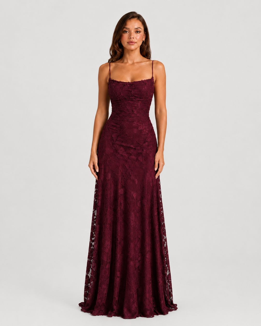 Woman wearing a textured floral maxi dress with a fitted bodice, delicate straps, elegant neckline, and flowing skirt for wedding guest and occasion wear.