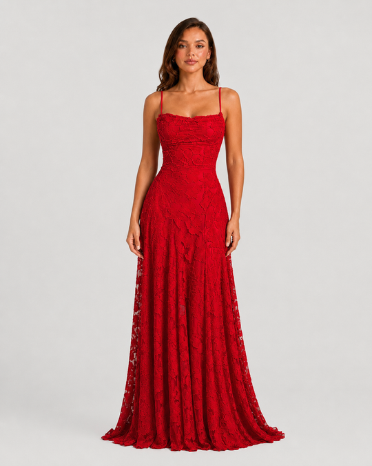 Woman wearing a textured floral maxi dress with a fitted bodice, delicate straps, elegant neckline, and flowing skirt for wedding guest and occasion wear.