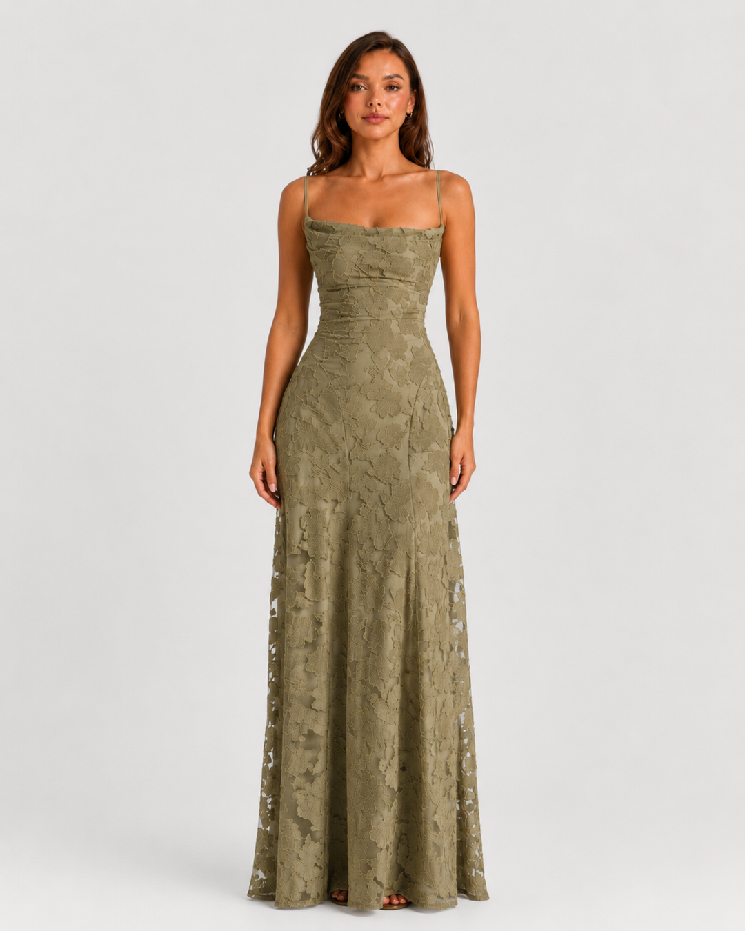 Woman wearing a textured floral maxi dress with a fitted bodice, delicate straps, elegant neckline, and flowing skirt for wedding guest and occasion wear.