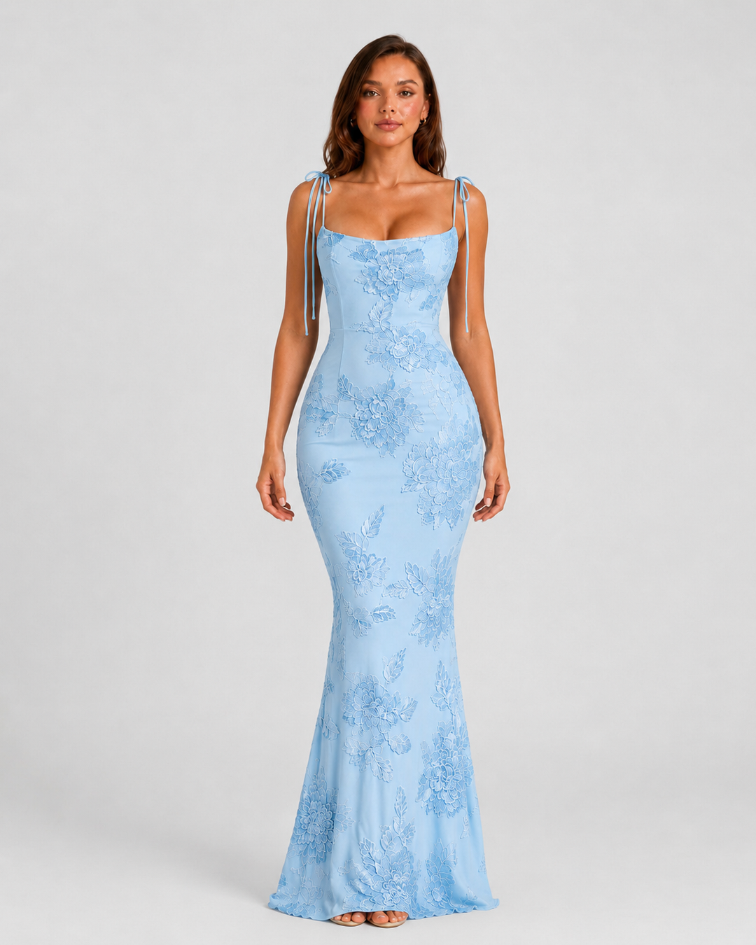 Women's embroidered floral maxi dress with adjustable tie straps, flowing silhouette, and delicate floral detailing for elegant occasion wear.