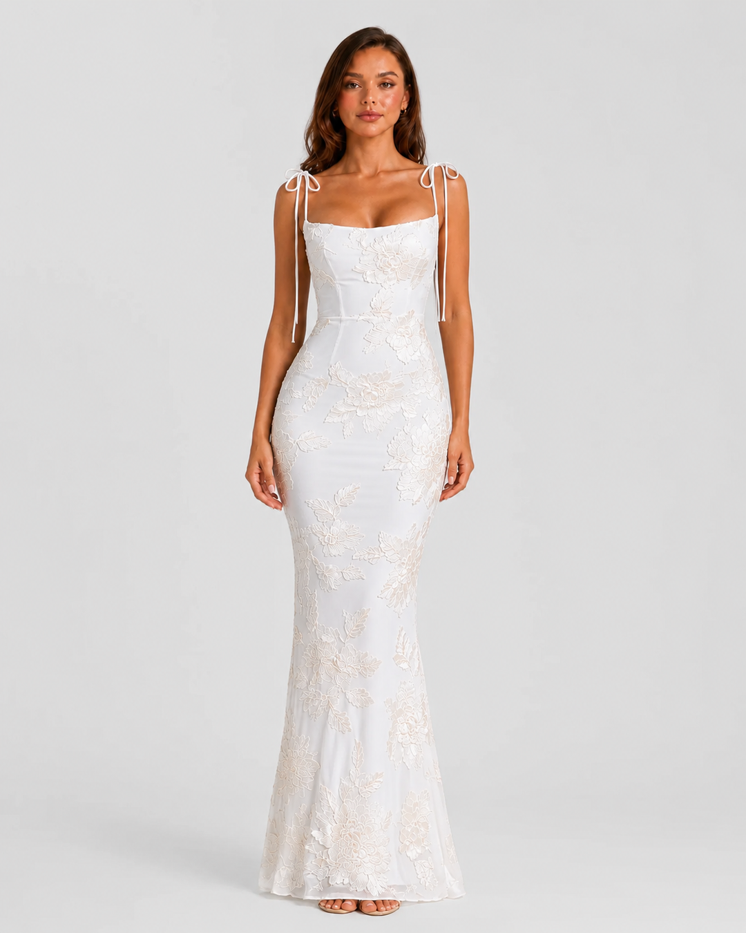 Women's embroidered floral maxi dress with adjustable tie straps, flowing silhouette, and delicate floral detailing for elegant occasion wear.