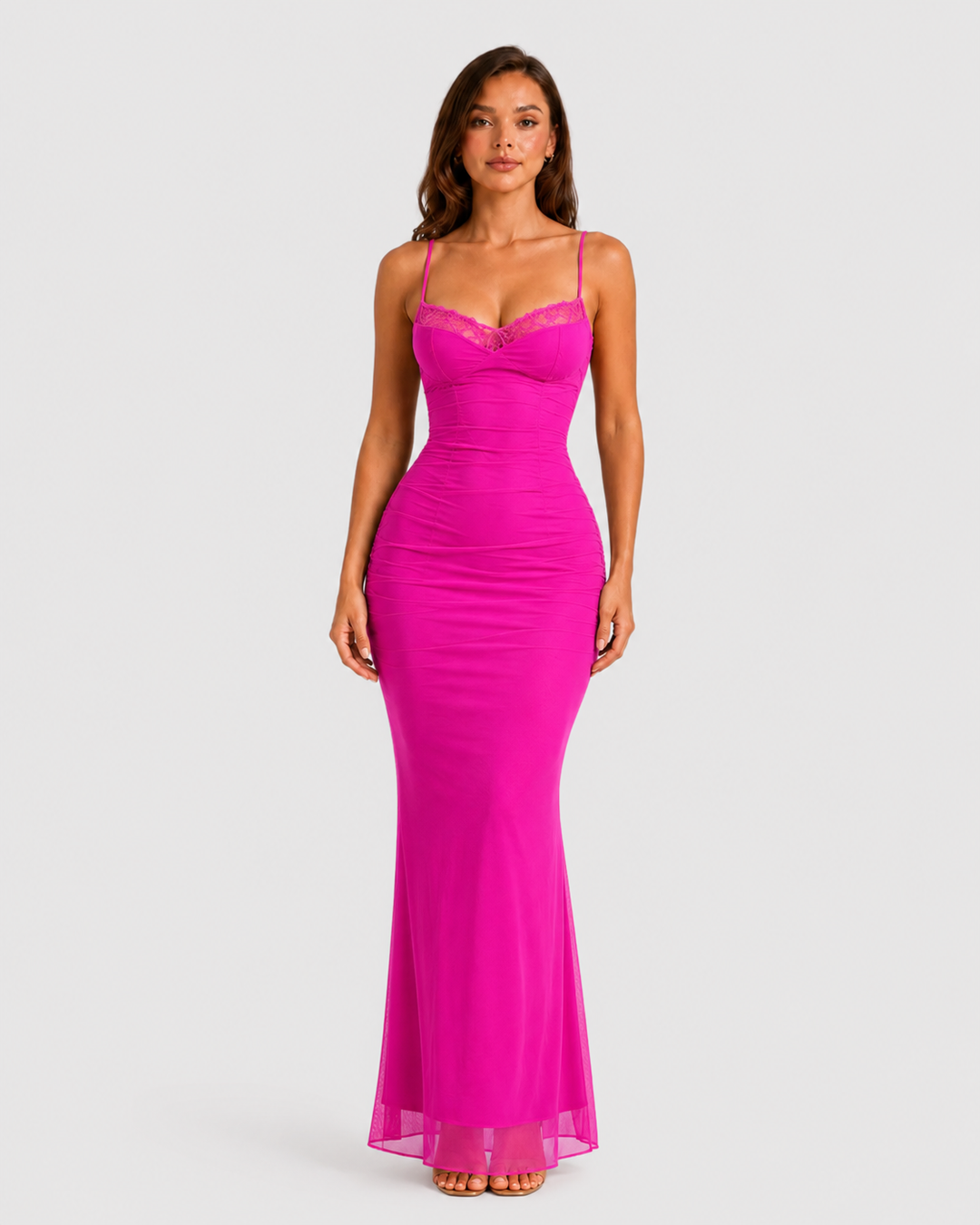 Woman wearing a fitted lace mesh corset dress with underwired cups, delicate lace trim, and a body-contouring silhouette designed for elegant evening occasions.