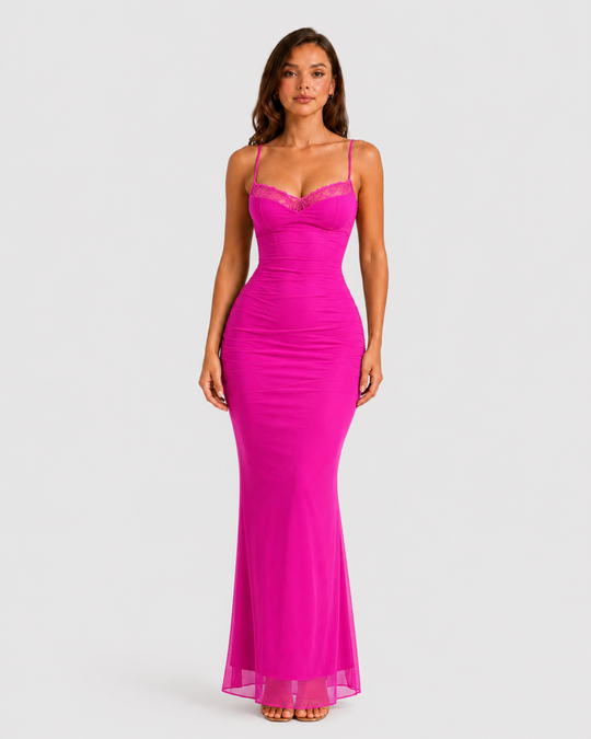 Woman wearing a fitted lace mesh corset dress with underwired cups, delicate lace trim, and a body-contouring silhouette designed for elegant evening occasions.