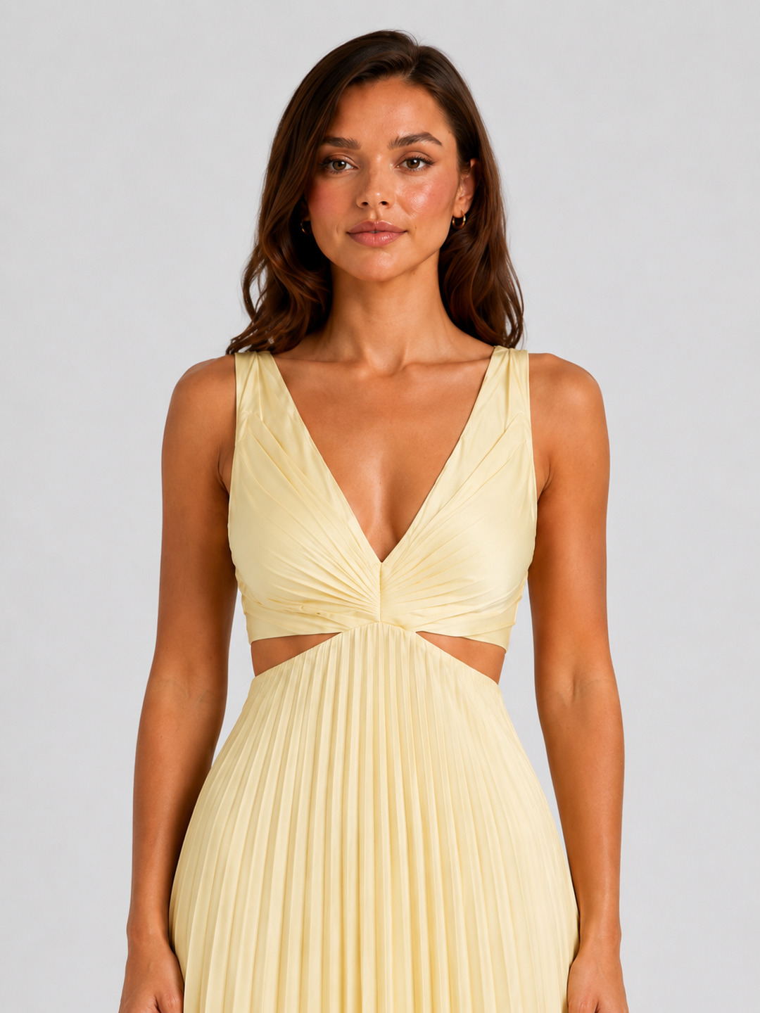Woman wearing a pleated midi dress with waist cut-outs, gathered V-neck bodice, and flowing skirt designed for elegant occasion dressing.