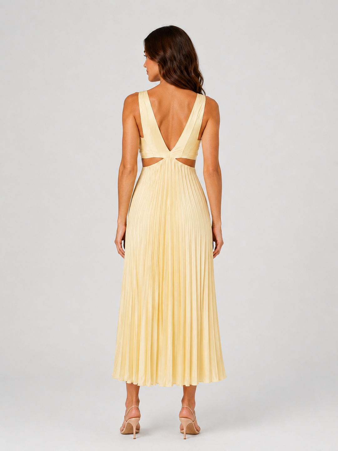 Woman wearing a pleated midi dress with waist cut-outs, gathered V-neck bodice, and flowing skirt designed for elegant occasion dressing.
